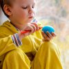 kid painting a ball