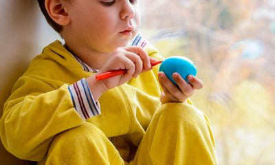 kid painting a ball