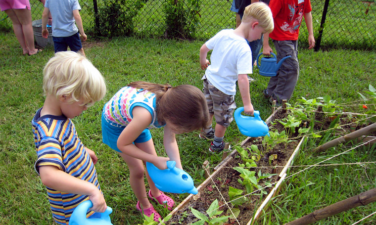 kids watering in the garden