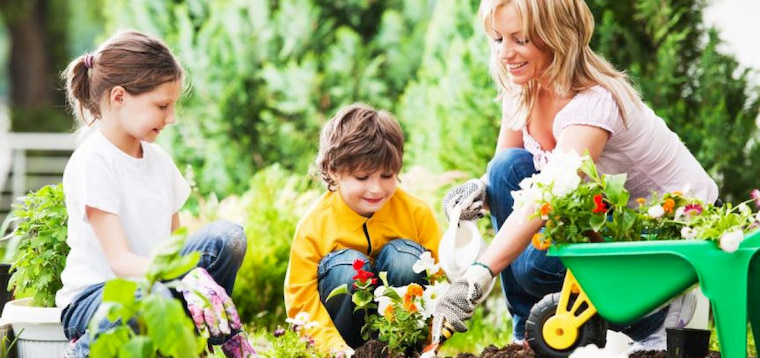 women with two kids gardening