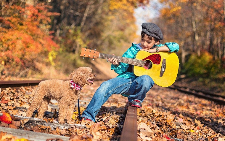 boy with dog and a guitar