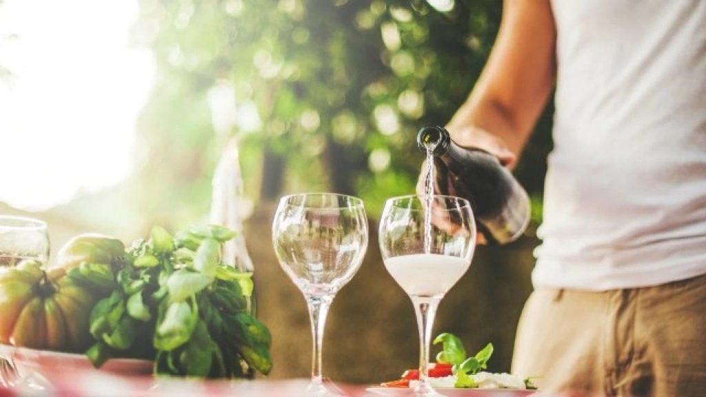 man drinking white wine