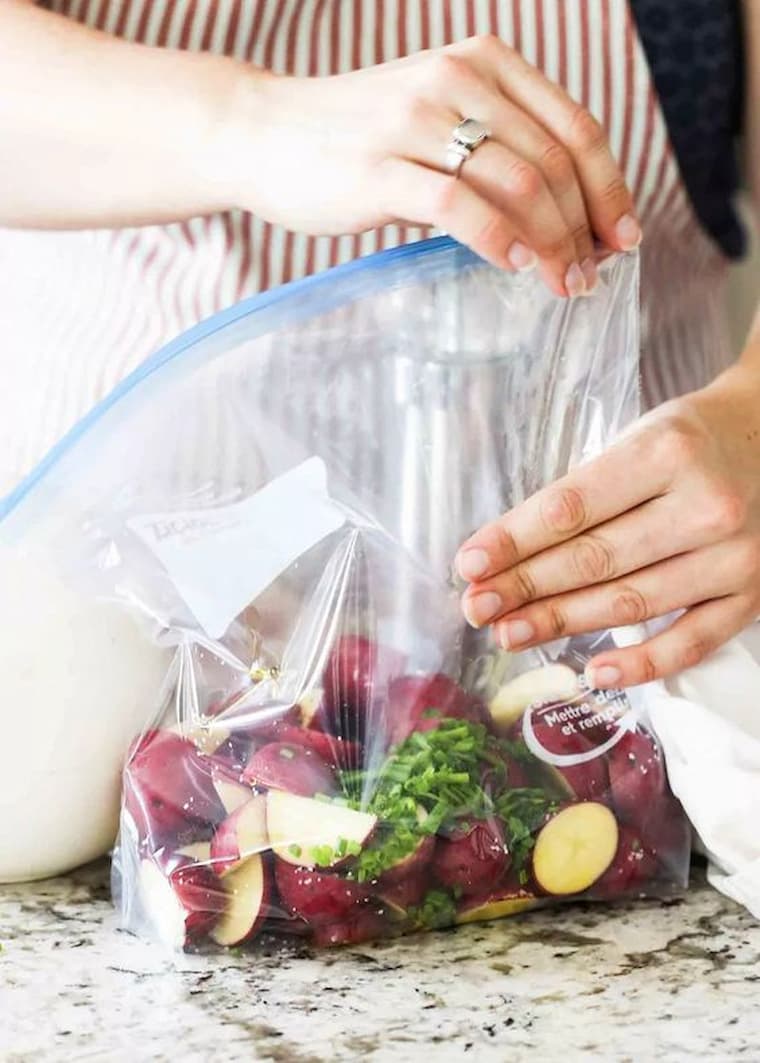 woman sealing food in a vacuum sealer 