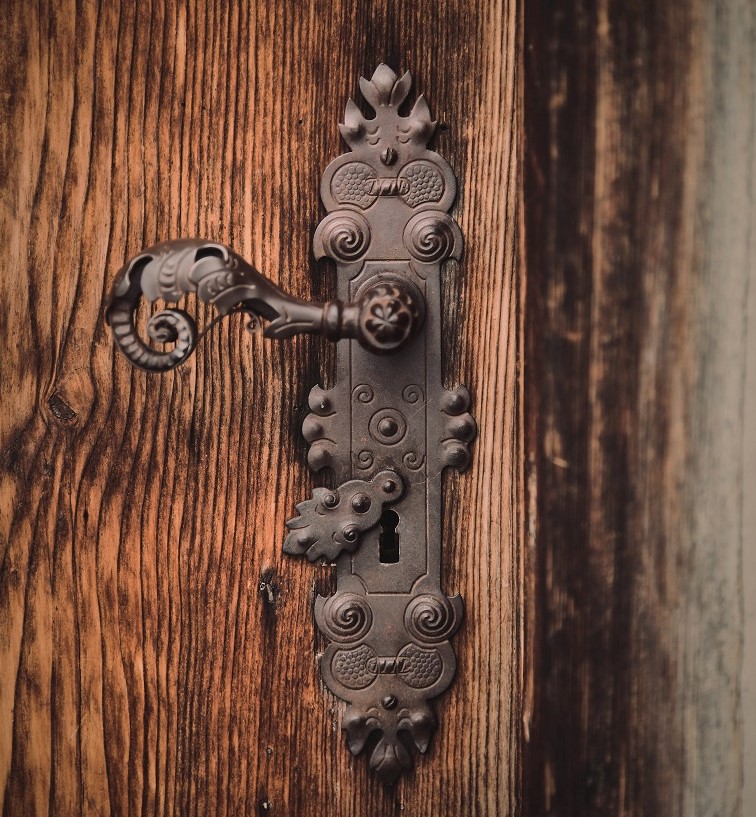 old school style door handle on wooden door