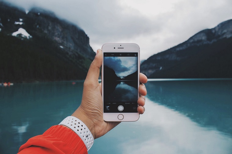 taking picture with refurbished Iphone on the lake