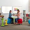 teacher discussing with student in classroom