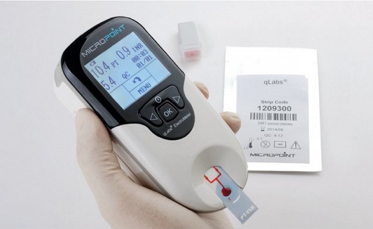 picture of INR Machine in persons hand being used