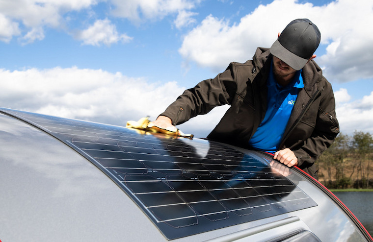 man cleaning flexible solar panel