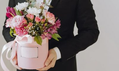 Man is holding box of flowers as a gift