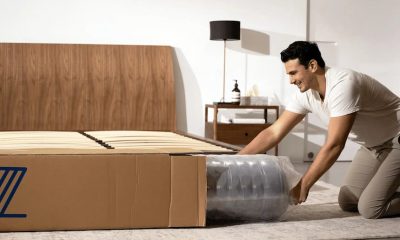 man is pulling out mattress from the box