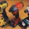 Assortment of Dewalt, Milwaukee, and Makita cordless power drills on wooden surface.