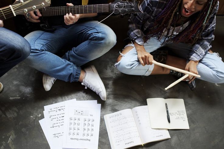 friends playing bass guitar and one of rhythmic instrument
