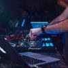 DJ playing music in a club with quality equipment